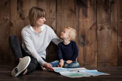 Mother talking to her son and holding a map