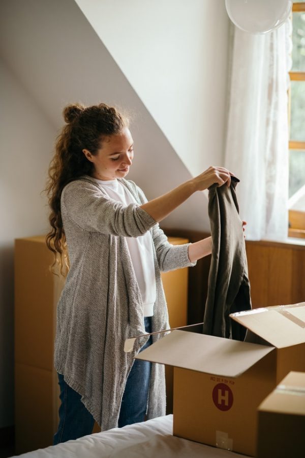 Woman unpacking from boxes.