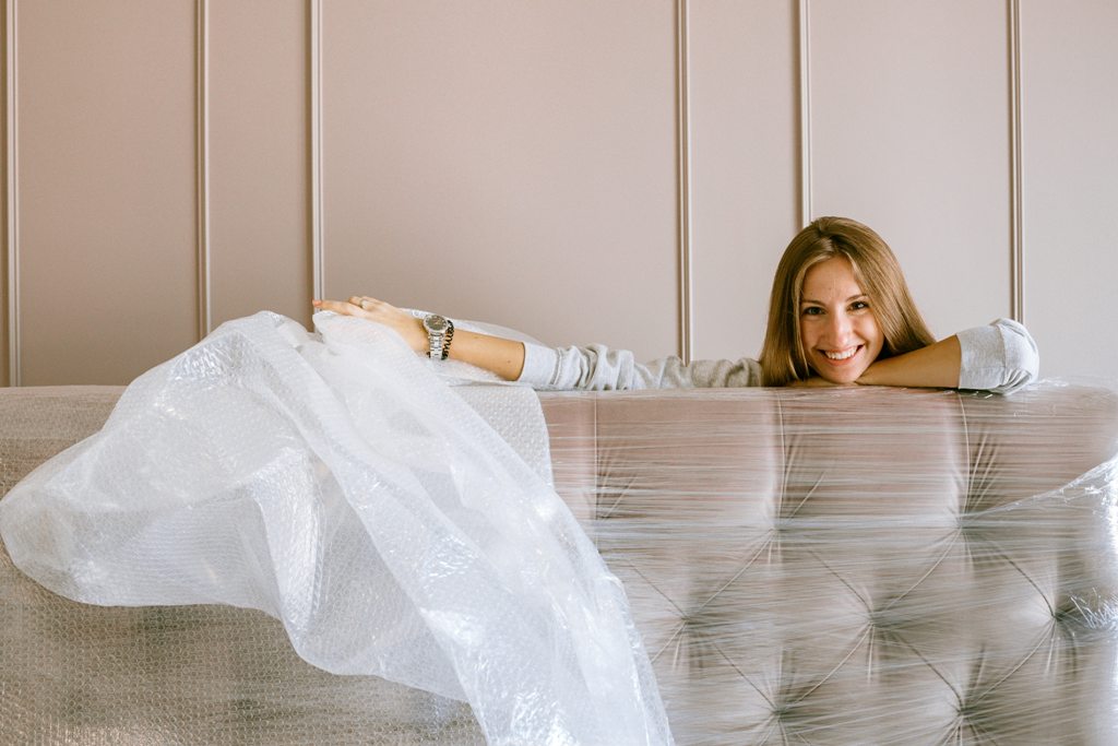 A woman packing a couch.