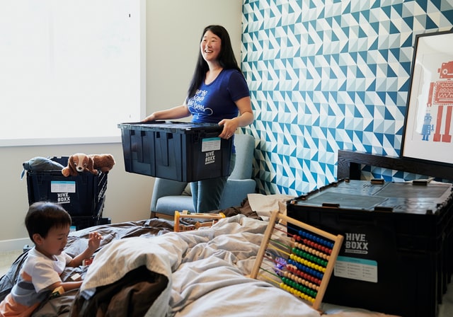 A woman cleaning out her home and carrying out furniture in order to protect it when moving.